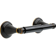 Black tissue holder with gold accents and round wall-mounted rosettes on each end.