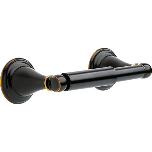 Black tissue holder with gold accents and round wall-mounted rosettes on each end.