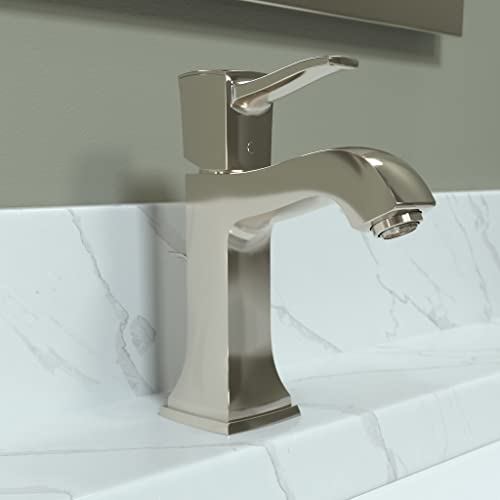 Polished nickel single-hole bathroom faucet with angular spout and lever handle mounted on white marble sink.