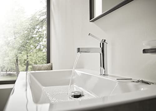 Chrome single-hole bathroom faucet with tall spout and pop-up drain installed on white sink.