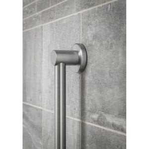 Brushed nickel stainless steel grab bar mounted vertically on gray tile wall.
