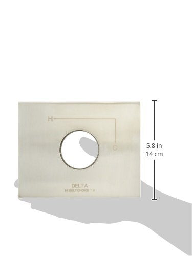 Stainless steel escutcheon kit with circular opening and Delta branding, mounted on wall with measurement scale showing 5.8 i