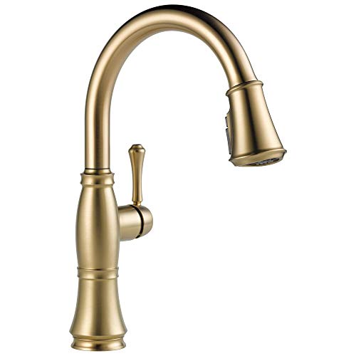 Champagne bronze kitchen faucet with curved spout, single lever handle, and pull-down spray head.