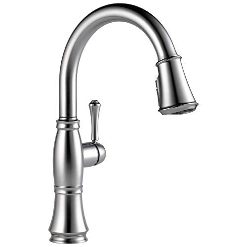 Chrome kitchen faucet with curved spout, single lever handle, and pull-down spray head.