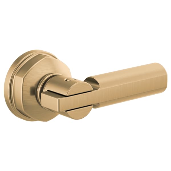 Brushed gold toilet flush lever with cylindrical handle attached to circular mounting plate.