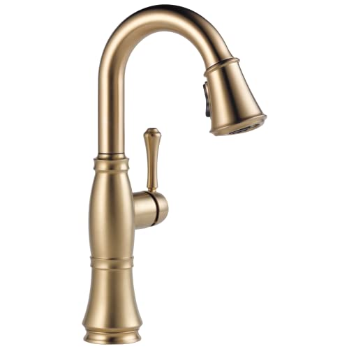 Champagne bronze single-handle kitchen faucet with pull-down spray head and curved spout.