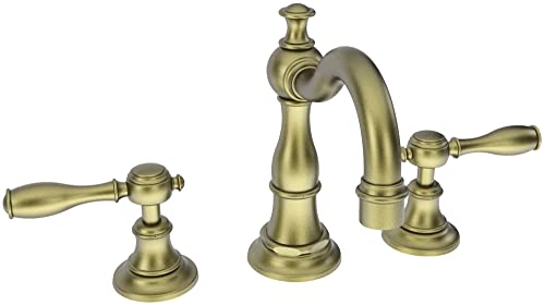 Antique brass three-piece widespread lavatory faucet with lever handles and curved spout.