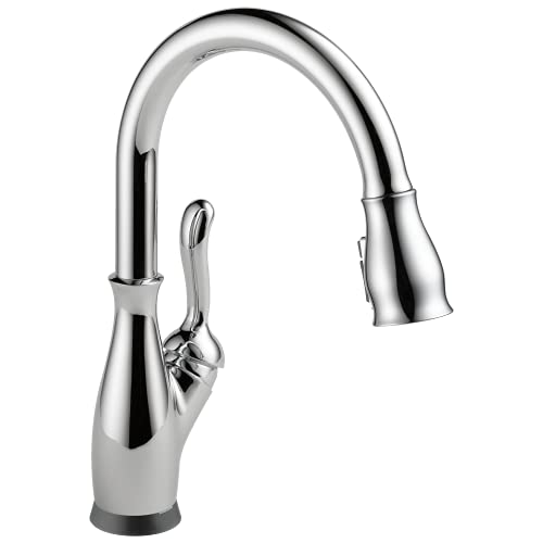 Chrome single-handle kitchen faucet with curved pull-down spout and lever handle.