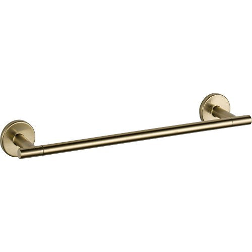 Brass towel bar with circular wall mounts on each end, mounted horizontally.