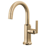 Brizo Kintsu beverage faucet with curved arc spout and single lever handle in brushed gold finish.