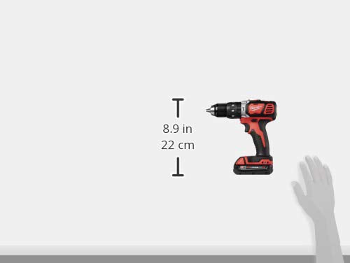 Red and black cordless drill with battery pack displayed next to measurement scale showing 8.9 inches.