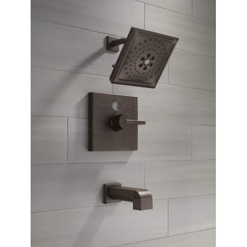 Venetian bronze shower valve trim kit with rectangular escutcheon plate, lever handle, showerhead, and tub spout mounted on w