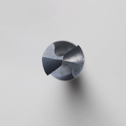 Black oxide 1/2 inch drill bit with twisted flutes and pointed tip on white background.
