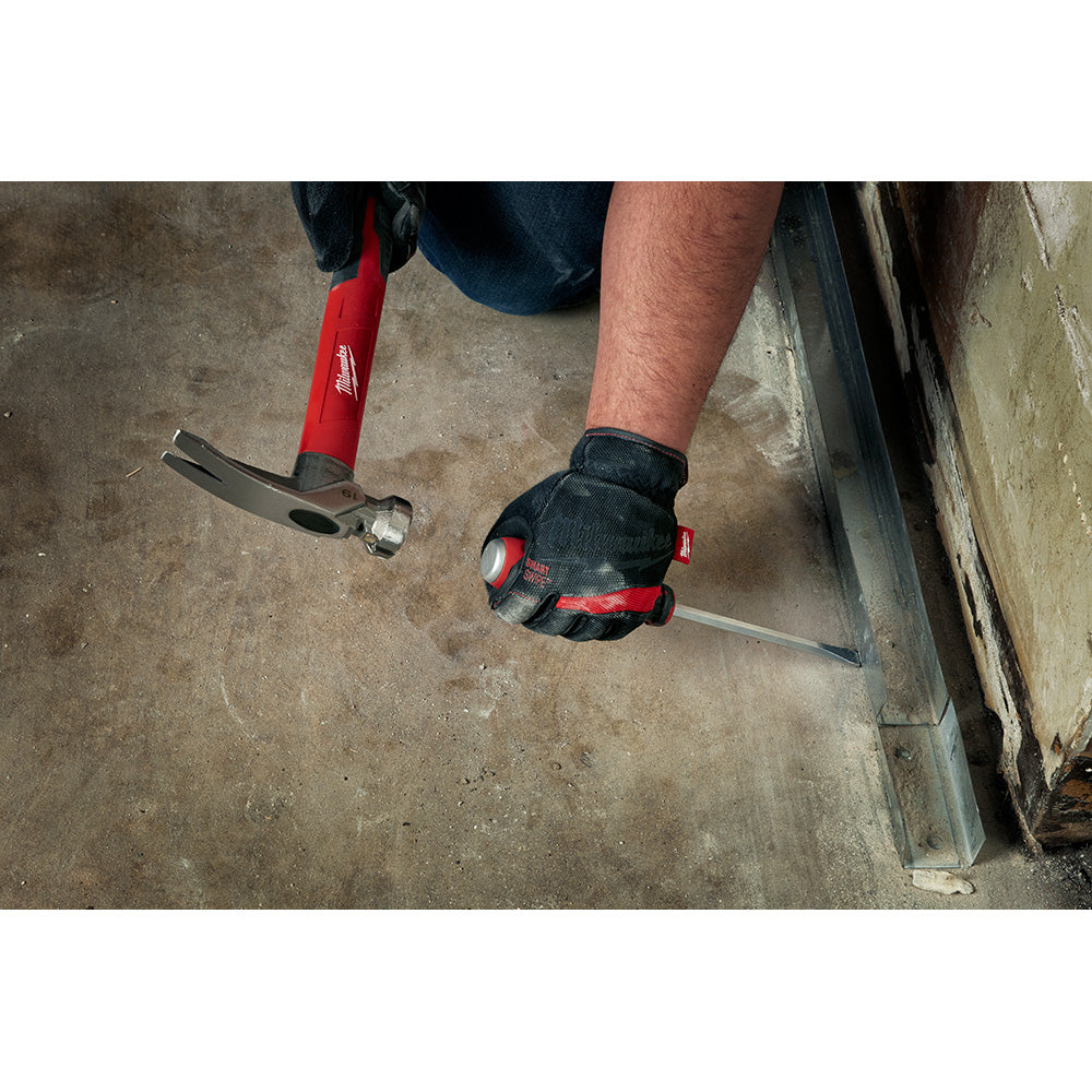 Two Milwaukee screwdrivers with red handles and black grips held in a work glove during use on concrete.