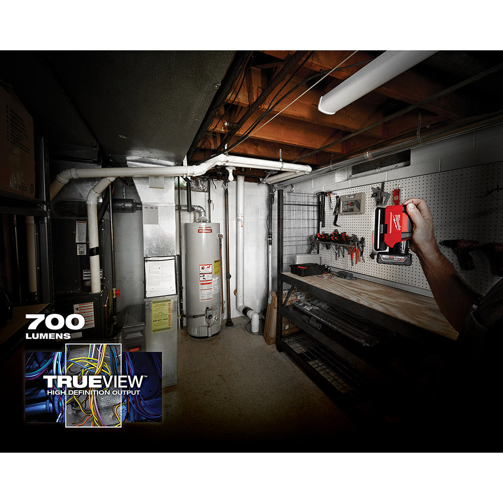 White LED flood light mounted horizontally on basement ceiling, illuminating workshop space with water heater and pegboard wa
