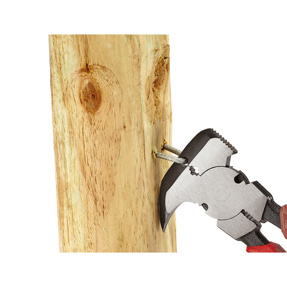 Fencing pliers with black and red handles gripping a nail in wood.