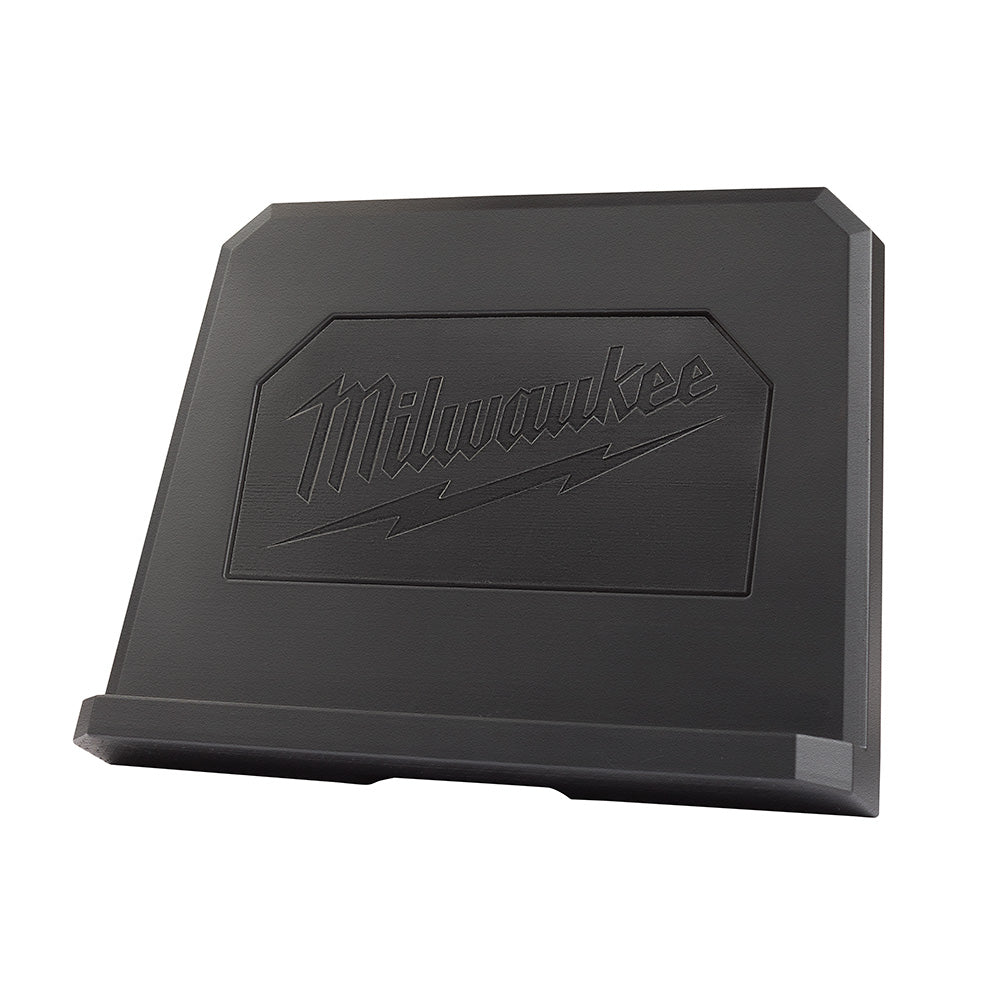 Black plastic tablet mount stand with Milwaukee logo embossed on front face and angled support base.
