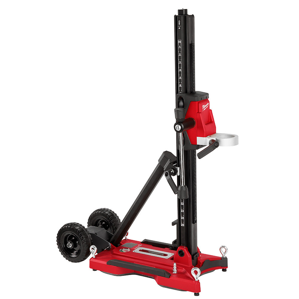 Red and black Milwaukee core drill stand with vertical black mast, red base, two black wheels, and side handle.