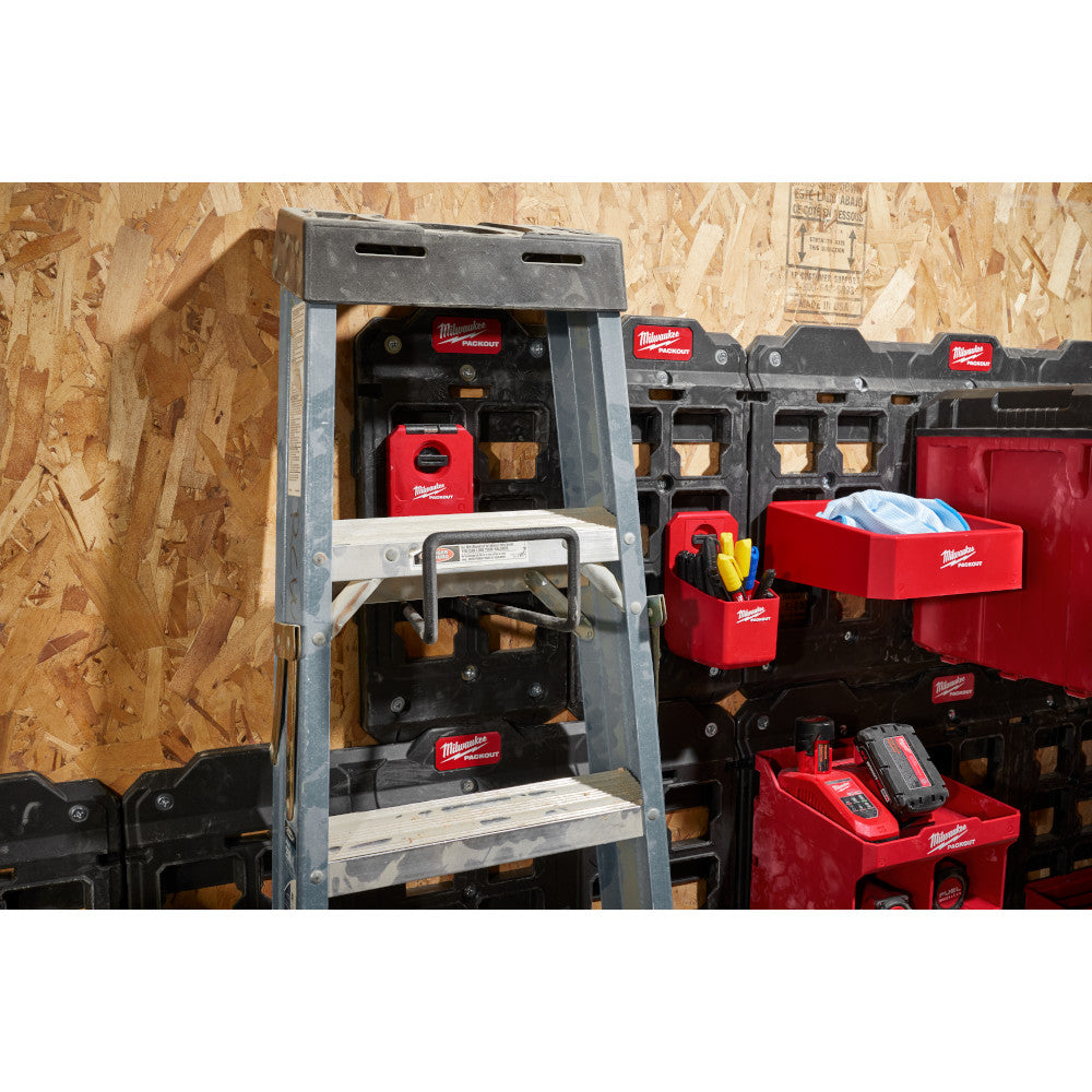 Black wide hook mounted on gray Milwaukee PACKOUT storage system with tools and accessories visible inside.