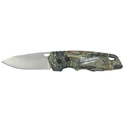Milwaukee FASTBACK folding knife with camouflage handle, silver blade, and Milwaukee branding visible.