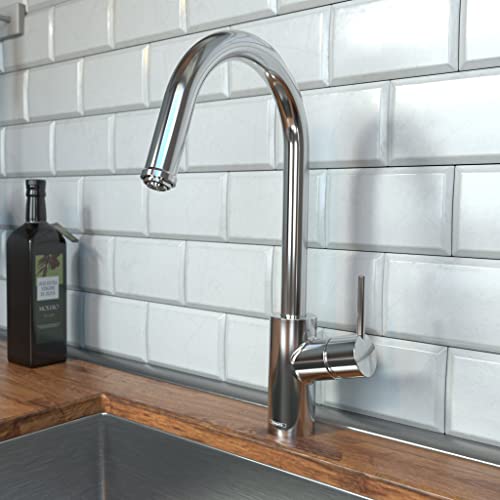 Chrome kitchen faucet with high arc spout and pull-down spray head mounted on wooden countertop against white subway tile bac