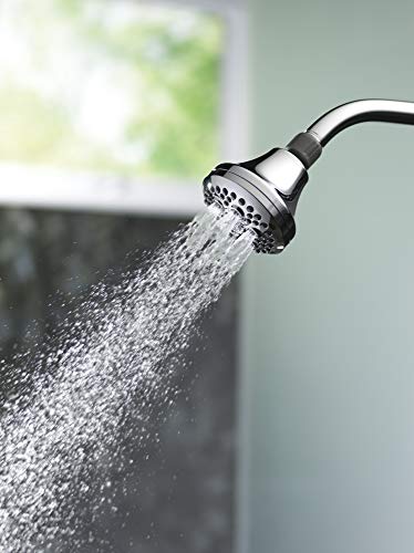 Chrome shower head with curved arm spraying water in multiple streams against blurred background.