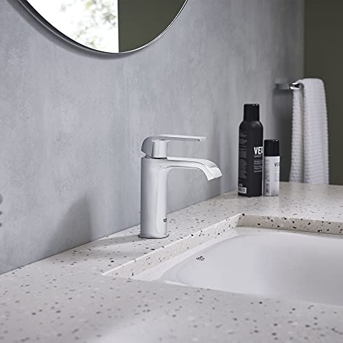White Grohe Eurocube faucet mounted on speckled countertop above undermount bathroom sink.