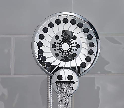 Chrome shower head with multiple spray holes arranged in concentric circles, connected to a flexible hose with water flowing.