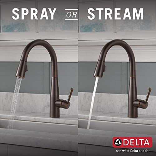 Bronze pull-down kitchen faucet shown in spray and stream modes with flexible hose.