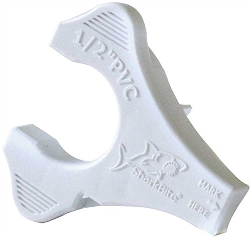 White plastic PVC disconnect clip and depth gauge with shark bite branding and measurement markings.