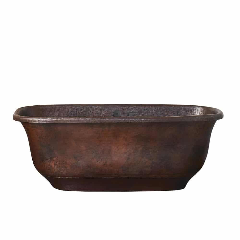 Antique copper bathtub with dark patina finish and rolled rim edges, oval basin shape.