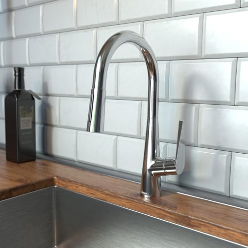 Chrome kitchen faucet with high curved arc spout and pull-down spray head mounted on sink counter.