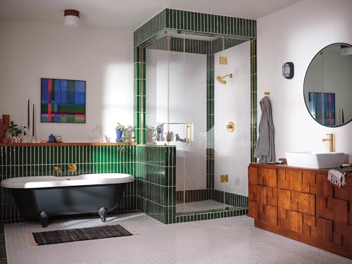 Brushed gold single-handle wall-mounted tub filler faucet with 10-inch spout reach installed above black bathtub.