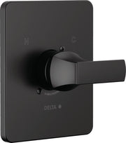 Matte black Delta shower valve trim with lever handle and rectangular escutcheon plate marked with H and C indicators.