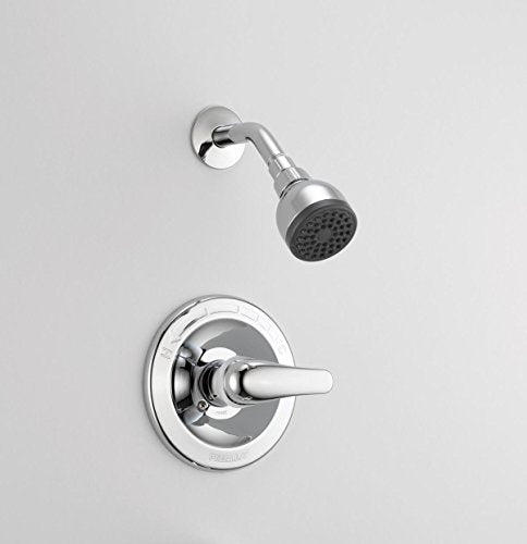 Chrome shower valve with single lever handle and round showerhead mounted on white wall.