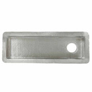 Hammered copper rectangular bar sink with single drain hole on right side, viewed from above.