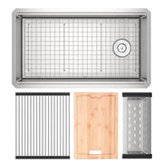 Brushed stainless steel rectangular workstation sink with drain, accompanied by metal grid, wooden cutting board, and stainle