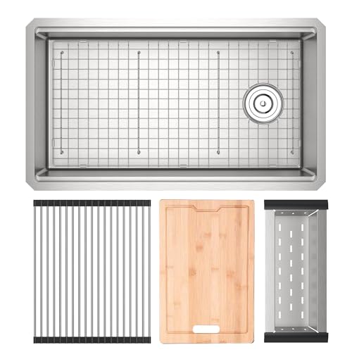 Brushed stainless steel rectangular workstation sink with drain, accompanied by metal grid, wooden cutting board, and stainle