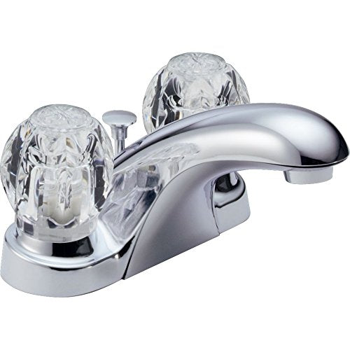 Chrome two-handle centerset bathroom faucet with clear knob handles and pop-up drain assembly.