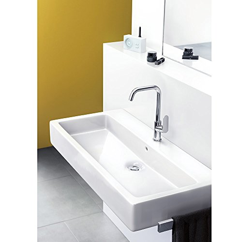 Chrome single-hole faucet with tall curved spout installed above white rectangular bathroom sink.