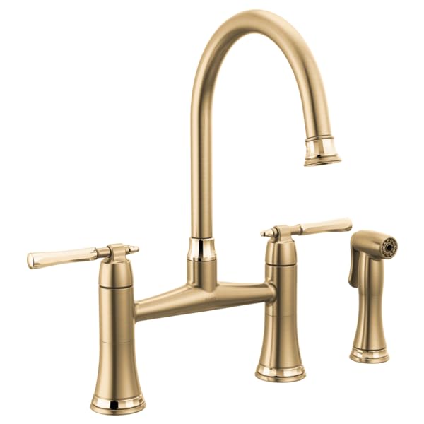 Champagne bronze bridge kitchen faucet with high arching spout, two lever handles, and side spray attachment.