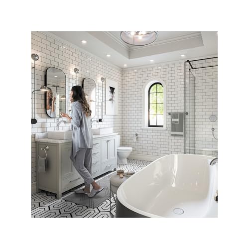 Polished nickel single-hole bathroom faucet with curved spout installed on white vanity sink.