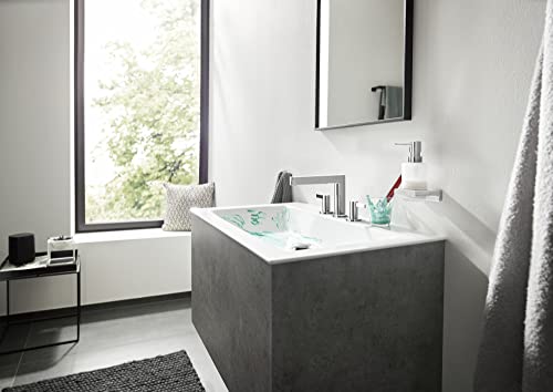 Chrome widespread faucet with tall spout installed on concrete bathroom sink.