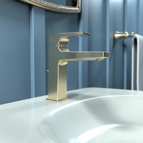 Brushed bronze single-hole bathroom faucet with lever handle mounted on white sink basin.
