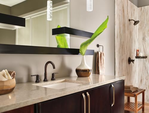 Polished nickel towel ring mounted on bathroom wall above vanity counter.