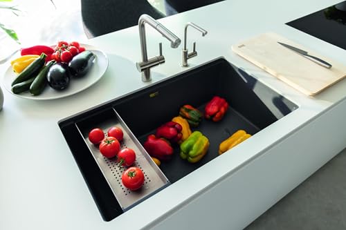 Black granite undermount kitchen sink with single bowl and divided colander insert, chrome faucet visible.