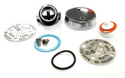 Vacuum breaker repair kit components including metal caps, diaphragms, gaskets, and internal seals arranged on white backgrou
