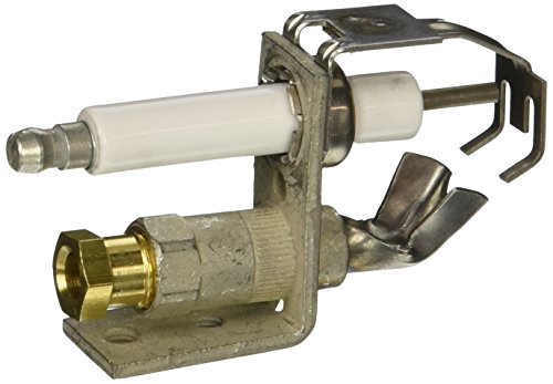Natural gas pilot burner igniter with ceramic electrode and brass connector on metal mounting bracket.