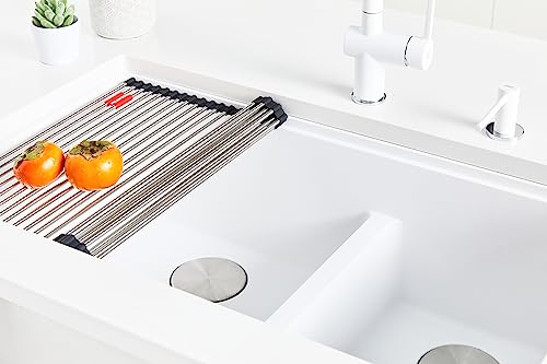 Stone grey undermount granite sink with single rectangular bowl installed in white countertop, shown with drying rack and fau
