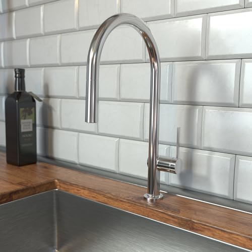 Chrome high-arc kitchen faucet with pull-down sprayer head mounted on wooden countertop with white subway tile backsplash.